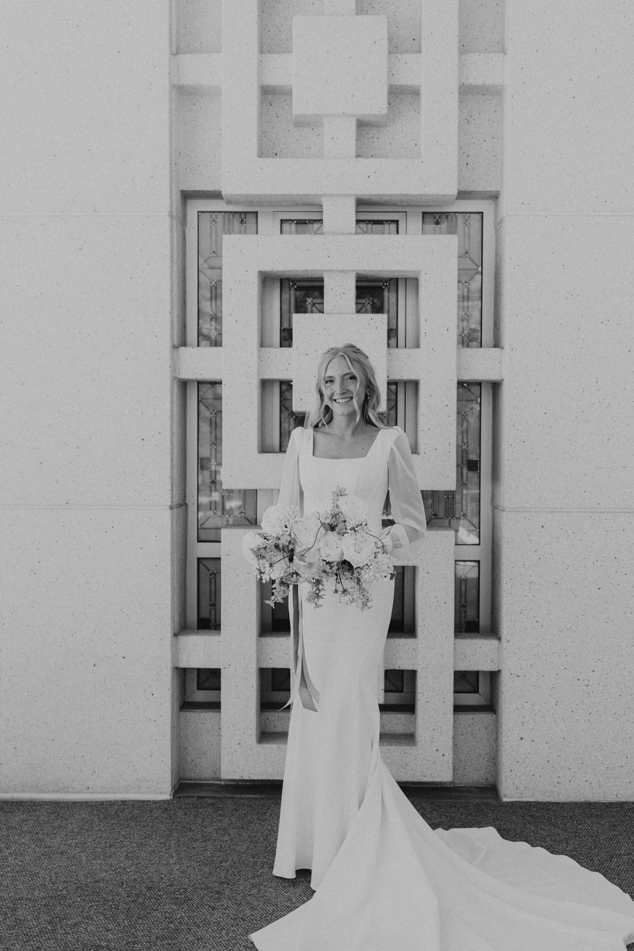 Ella, founder of Ella Kate Jewelry, on her wedding day holding a bouquet