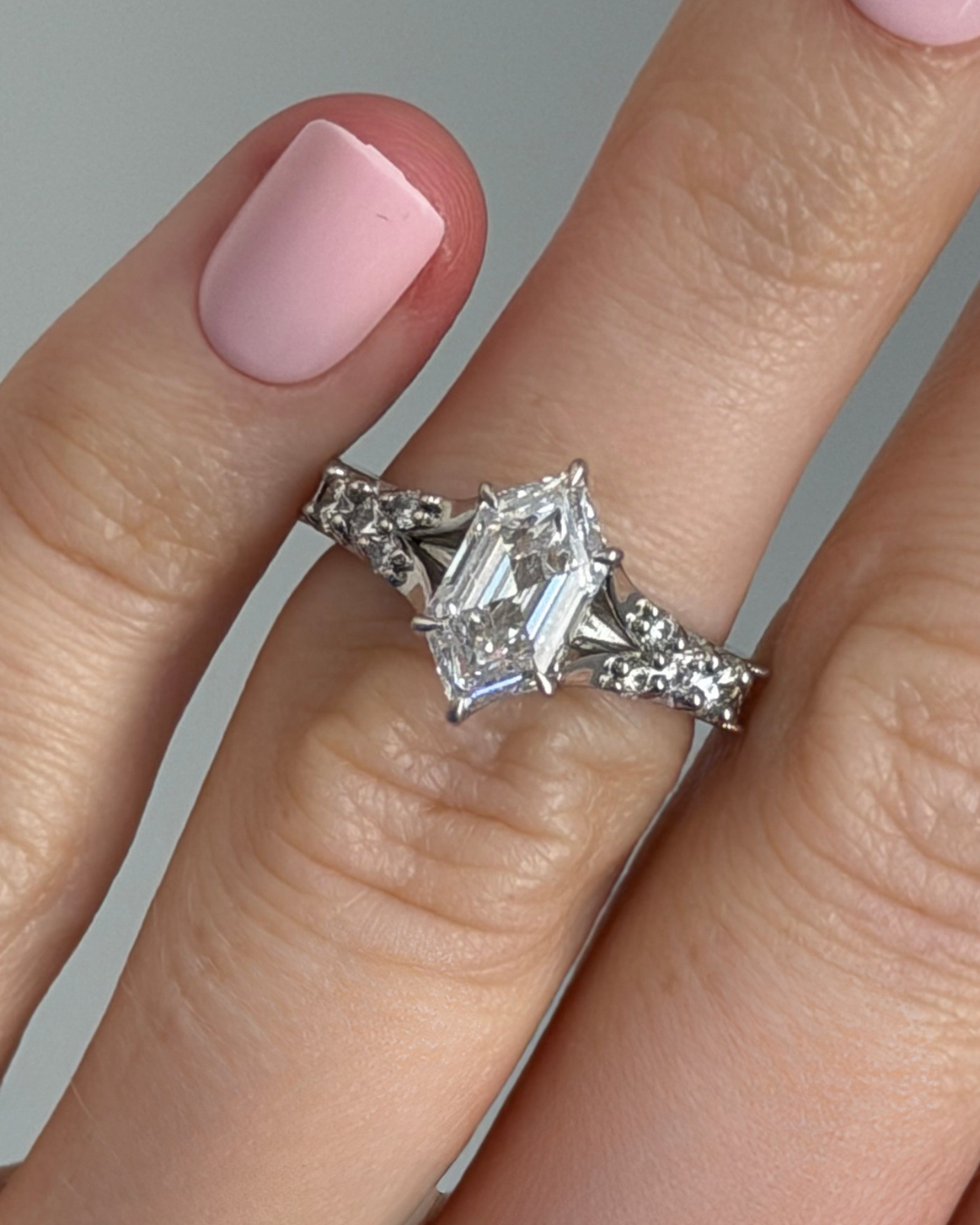 Angular white gold ring with tapered diamond accents